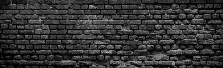 Fototapety  Old black brick wall background.