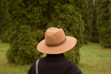 woman in hat walking alone in the beautiful autumn park