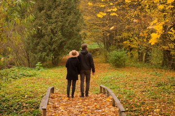 couple of tourist walking having good time in autumn park  