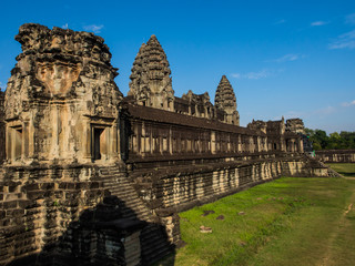 The collapse ancient remains with the green grass field. The wall lines with the pattern of the...