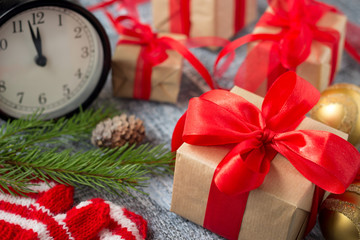 Christmas decorations. Present boxes and christmas balls near alarm clock.