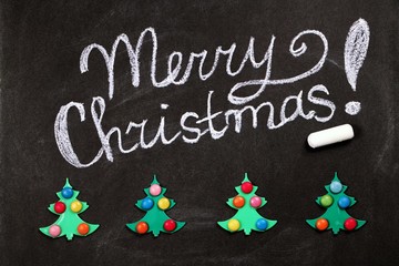 Christmas background with an inscription on chalkboard . Top view