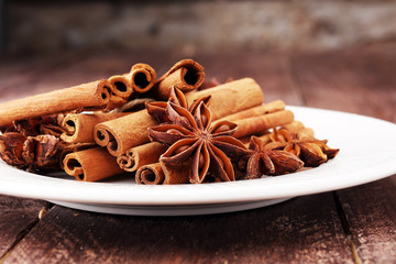 Fragrant star anise and cinnamon on wooden table.