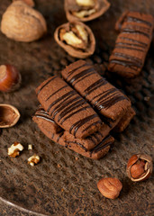 Homemade cookies with walnuts, hazelnut and chocolate on vintage an old rustic baking tray.