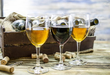 Three glasses of wine on a wooden table. Wine of a new harvest background
