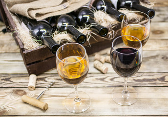 Three glasses of wine on a wooden table. Wine of a new harvest background