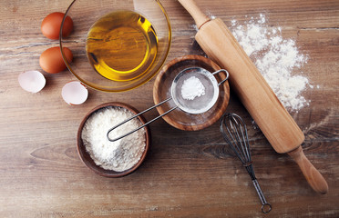 Baking ingredients for homemade pastry on wooden background. Bake sweet cookies concept