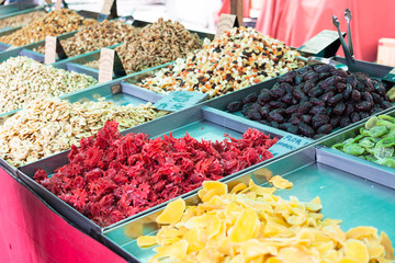 Dried Hibiscus flowers (flor de hibiscus), mango, kiwi, dates, banana (platano seco) and a variety of nuts for sale in the stall of Sineu market, Majorca, Spain