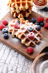 Traditional belgian waffles with fresh blueberries, sugar and raspberries.
