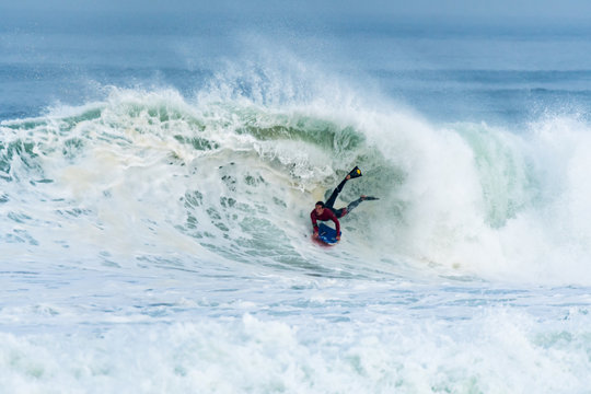 Bodyboarder surfing ocean wave