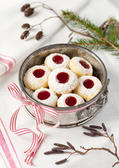 Homemade christmas cookies with raspberry jam filling in old metal cake baking pan.