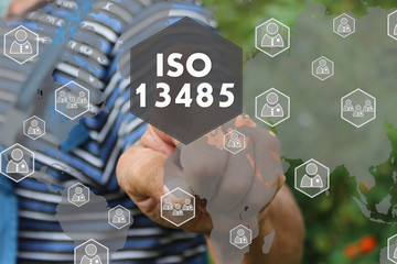 The businessman is choosing ISO 13485 touch on the world map. Requirements for the quality management system of manufacturers of medical products and equipment
