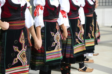 Serbian girls in traditional costume dancing