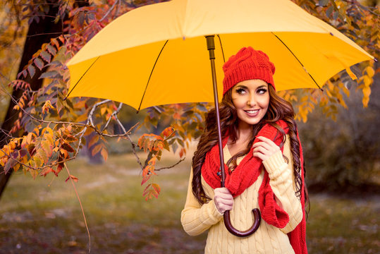 Happy Woman With Umbrella Walking In Autumn Park