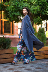 Fashionable beautiful girl in a dark blue flower dress