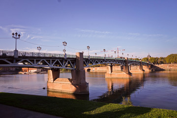Saint Pierre Bridge reflecting in Garonne river and Dome de la Grave at sunset in Toulouse, France