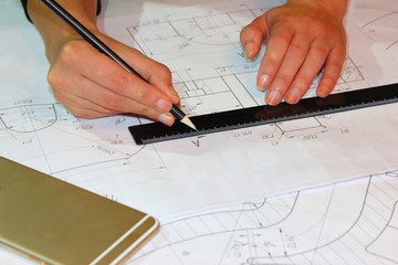 Open drawings with a pencil. Engineering and design. Construction projects. Planning.