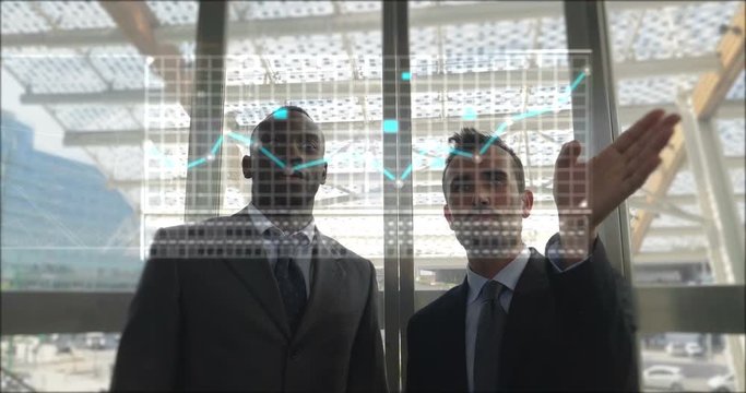  Two businessmen discuss economics and hand touches themselves to see the financial holographic trends in holography appearing in front of him. Concept of: increased reality and future 183 / 200 chara