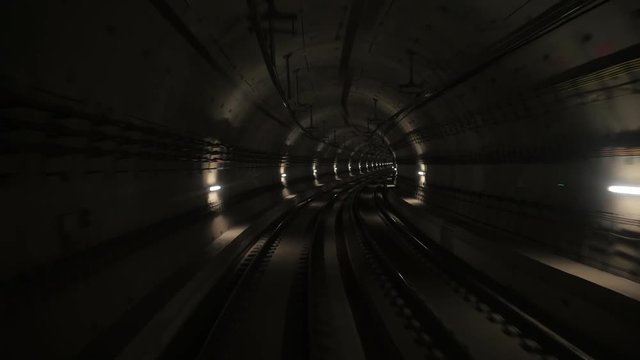 View of subway tunnel as seen from the rear of a moving backward train. Fast underground train riding in tunnel of modern city.Long footage of underground train in Barcelona following its route. 4k