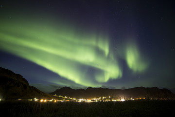 A typical shape of northern lights (aurora borealis) of the magnitude 4 over the town Vik (Iceland) in November © Pawel Sidlo