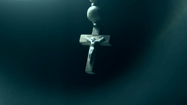 wooden rosary on a dark background closeup