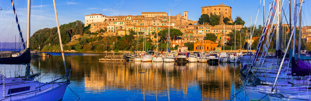 Wall mural travel in Italy - picturesque tranquil Capodimonte village in lake Bolsena over sunset.