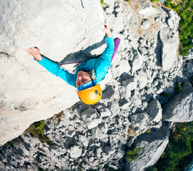 The girl climbs the rock.