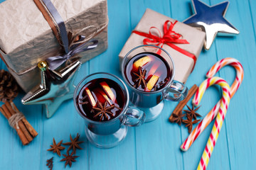 Mulled wine, gift boxes, candies and decorations on bright background. Celebration, Christmas eve, New year, hot drinks,winter concept