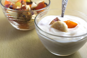 2 glass bowls with yoghurt and fruit salad