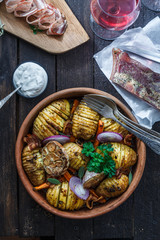 Potatoes with carrots close up in a bowl, vertical, rustic style