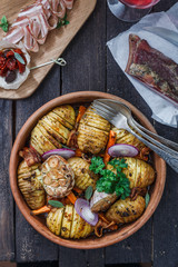 Potatoes with carrots close up in a bowl, vertical, rustic style