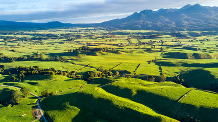 Aerial view on a farmland with stock paddocks at the foot of Mount Taranaki. Taranaki region, New Zealand