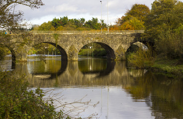 Fototapeta premium The ancient stone built Shaw's Bridge over the River Lagan close to the little mill village of Edenderry on the outskirts of South Belfast in Northern Ireland