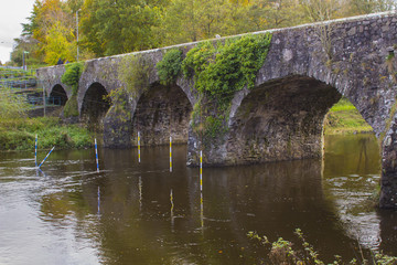 Fototapeta na wymiar The ancient stone built Shaw's Bridge over the River Lagan close to the little mill village of Edenderry on the outskirts of South Belfast in Northern Ireland