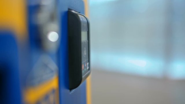 CloseUp of Paying by a Credit Card using Paypass Reader on a Ticket Vending Machine with Terminal