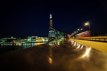 Obraz premium London Bridge with a red bus rushing past