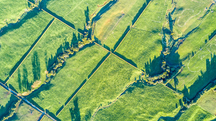 Aerial view on a farmland with stock paddocks at the foot of Mount Taranaki. Taranaki region, New Zealand