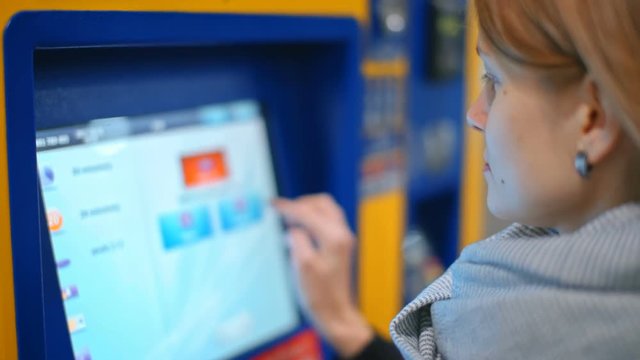 Nice Lady is Buying a Ticket in Automatic Vending Machine, Paying by Credit Card using Paypass