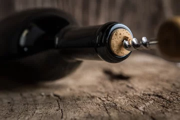 Rolgordijnen Corkscrew and bottle of wine on the board © poplasen