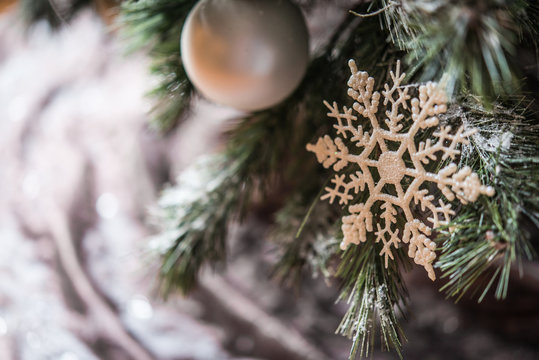 Snowflake ornament and bubles on Christmas tree, closeup and copy space
