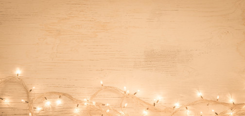Cgrsitmas ornamet led string lights on vintage wooden background