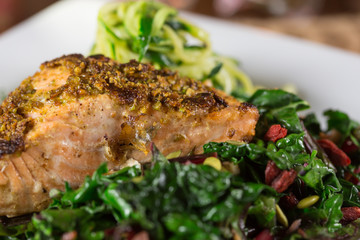 Pistachio Crusted Grilled Wild Salmon Fillet on a bed of Collard Greens and Zoodles (zucchini Noodle).