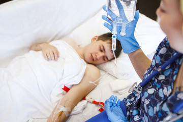A nurse injects a patient with a vein