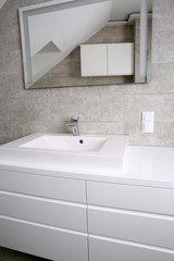 Furnished bathroom with white furniture, tiles in grey