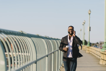 Man talking on phone walking along Key Bridge, Washington DC