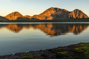 Amazing red Sunset landscape of Tevno lake, Pirin Mountain, Bulgaria