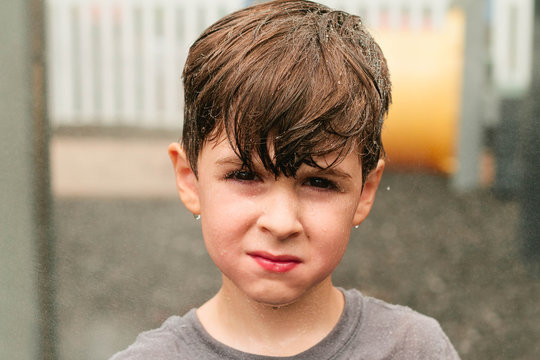 boy standing in misty spray