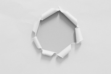 White ripped hole paper on gray paper background. copy space