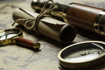 Retro compass with old map and spyglass