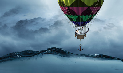 Businessman travel on air balloon